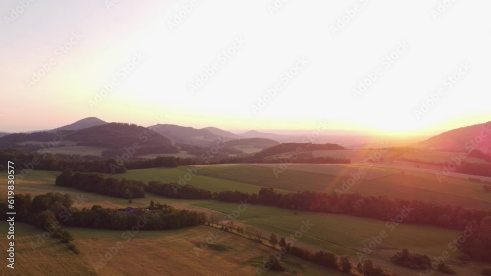 Aerial shot of a breathtaking sunset, illuminating the surrounding landscape with its orange light. Hiking lifestyle. 4k video Aerial shot of a breathtaking sunset, illuminating the surrounding landscape with its orange light. Hiking lifestyle. 4k video