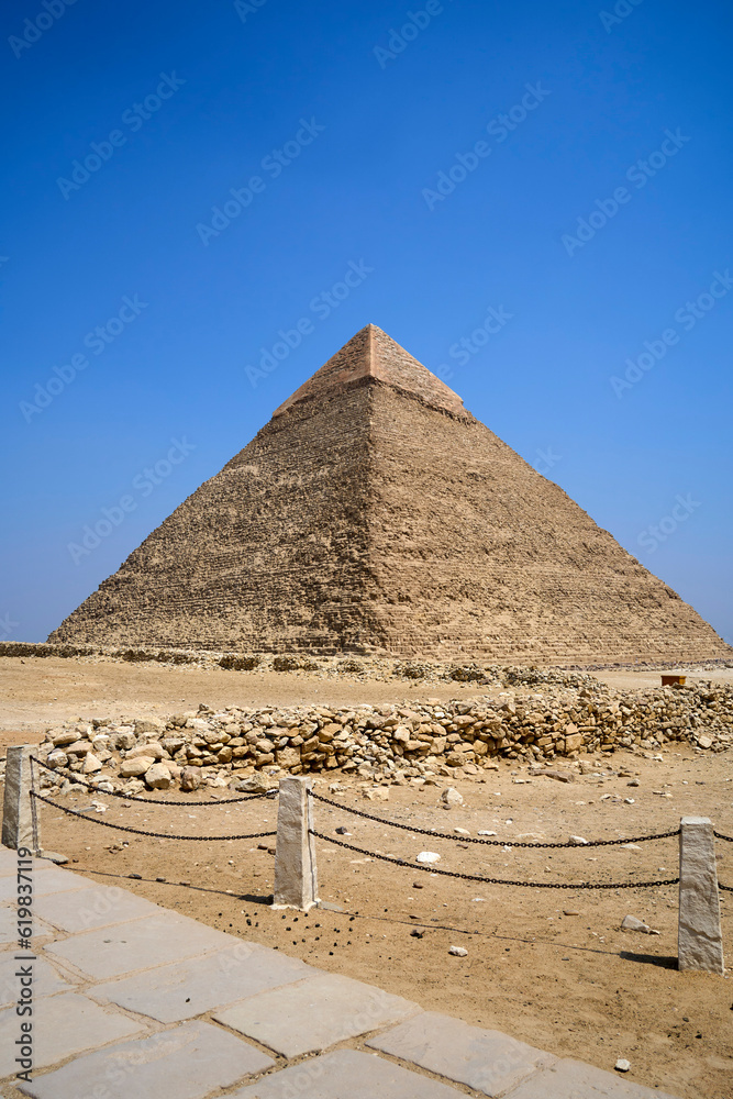 Khufu pyramid seen from the path leading through the plateu. The Great Pyramids of Giza, Giza Plateau, Cairo, Egypt Khufu pyramid seen from the path leading through the plateu. The Great Pyramids of Giza, Giza Plateau, Cairo, Egypt