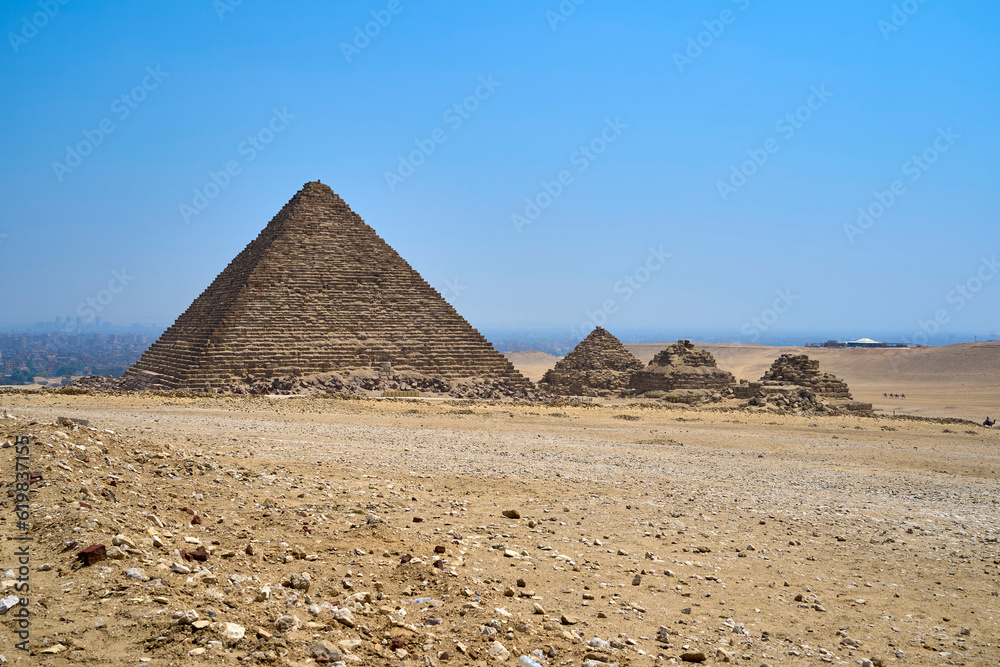 The pyramid Menkaure and three smaller pyramids. The Great Pyramids of Giza, Giza Plateau, Cairo, Egypt The pyramid Menkaure and three smaller pyramids. The Great Pyramids of Giza, Giza Plateau, Cairo, Egypt