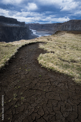 Dry ground full of cracks next to the canyon with the river jökula a fjöllum in iceland in summer