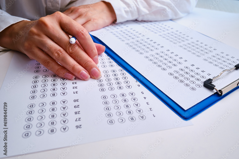 Admission test. Examination form. Choosing the correct answer. A sheet of paper with a test task. School exam. University quiz. Right or wrong option. Student to study. Elementary school question Admission test. Examination form. Choosing the correct answer. A sheet of paper with a test task. School exam. University quiz. Right or wrong option. Student to study. Elementary school question