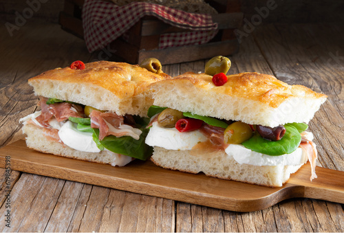 focaccia pizza  with ham, mozzarella, salads and olives photo