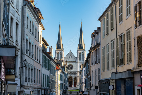Narrow alley with picturesque houses, typical windows and church of St. Jacques in Pau, France. © josemiguelsangar