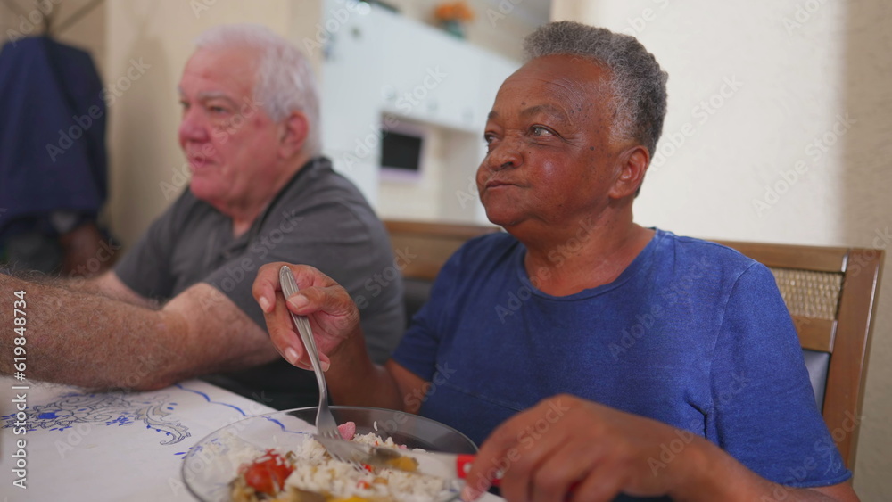 Elderly woman eating lunch at meal time, a group of diverse senior over meal. Close-up of a Brazilian older lady eats food Elderly woman eating lunch at meal time, a group of diverse senior over meal. Close-up of a Brazilian older lady eats food