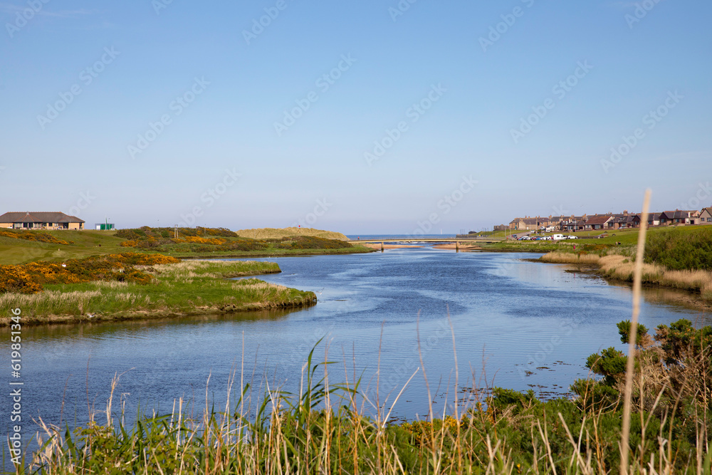 The river Ugie looking towards the town of Peterhead and the village of Buchanhaven on the right with the golf club and golf course on the left. A bridge and the sea are in the distance. The river Ugie looking towards the town of Peterhead and the village of Buchanhaven on the right with the golf club and golf course on the left. A bridge and the sea are in the distance.