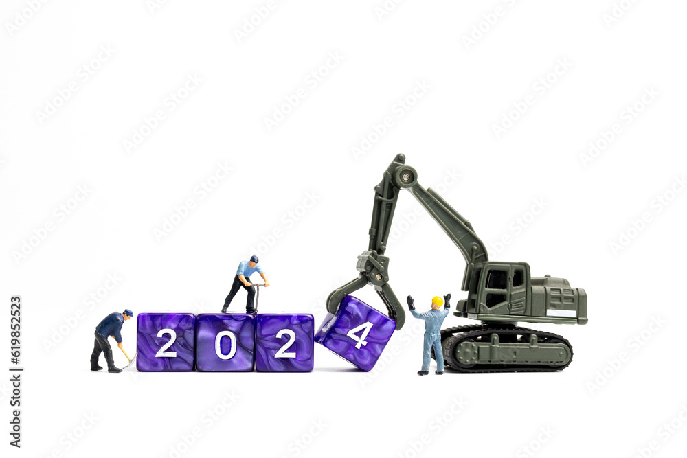 Miniature people , Worker team flips a block with the number 2024, On a white background Miniature people , Worker team flips a block with the number 2024, On a white background