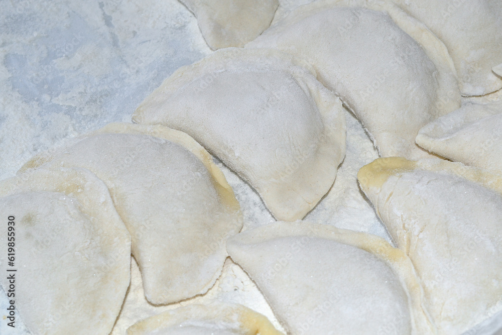 Many dumplings are stuck on and are lying on the table Many dumplings are stuck on and are lying on the table