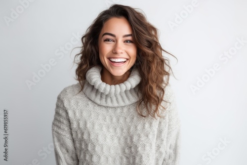 Portrait of a smiling young woman in sweater isolated on a white background