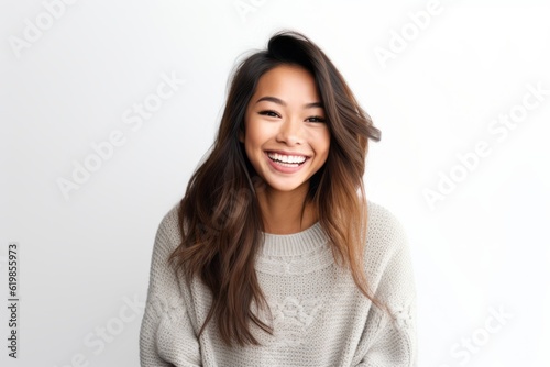 Portrait of a beautiful young asian woman smiling against white background