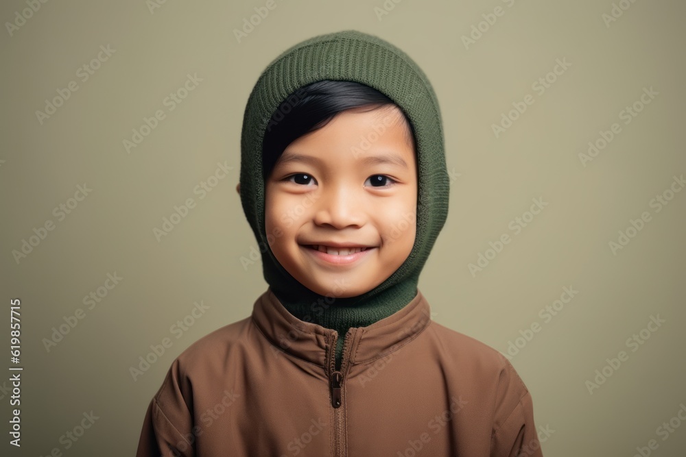 Portrait of a cute little asian boy in warm clothes and hat