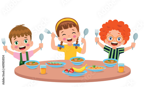 Boy and girls eating at the dining table