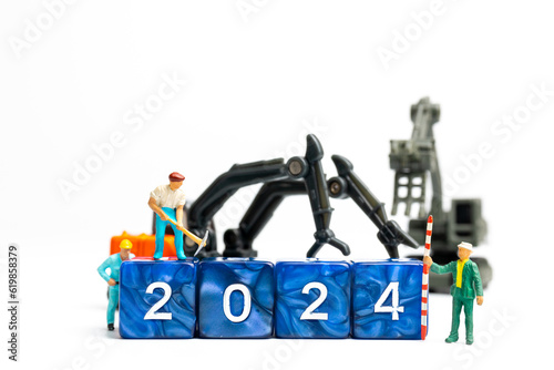 Wallpaper Mural Miniature people , Worker team flips a block with the number 2024, On a white background Torontodigital.ca