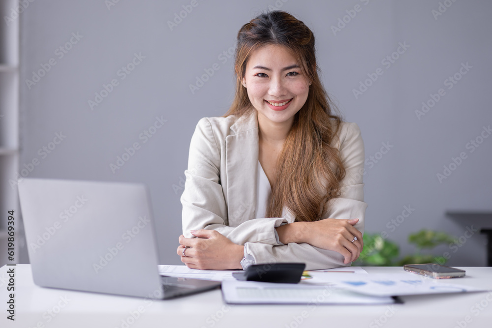 Financial Business asian women analyze the graph of the company's performance to create profits and growth, Market research reports and income statistics, Financial and Accounting concept. Financial Business asian women analyze the graph of the company's performance to create profits and growth, Market research reports and income statistics, Financial and Accounting concept.