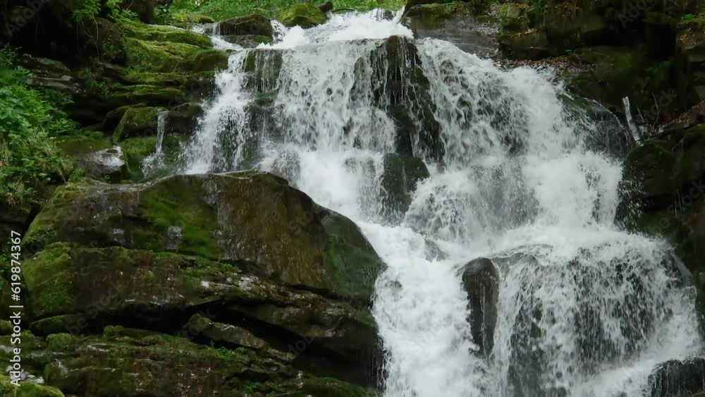 Waterfall on mountain river in beech forest in Carpathian Mountains Waterfall on mountain river in beech forest in Carpathian Mountains