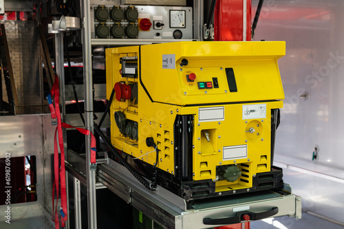 Bright yellow control panel for water supply and main appliances of a fire truck. Close up.