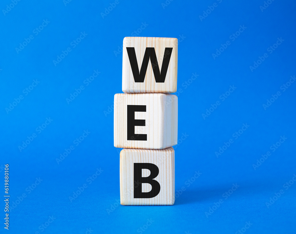 Web symbol. Wooden cubes with word Web. Beautiful blue background. Business and Web concept. Copy space. Web symbol. Wooden cubes with word Web. Beautiful blue background. Business and Web concept. Copy space.