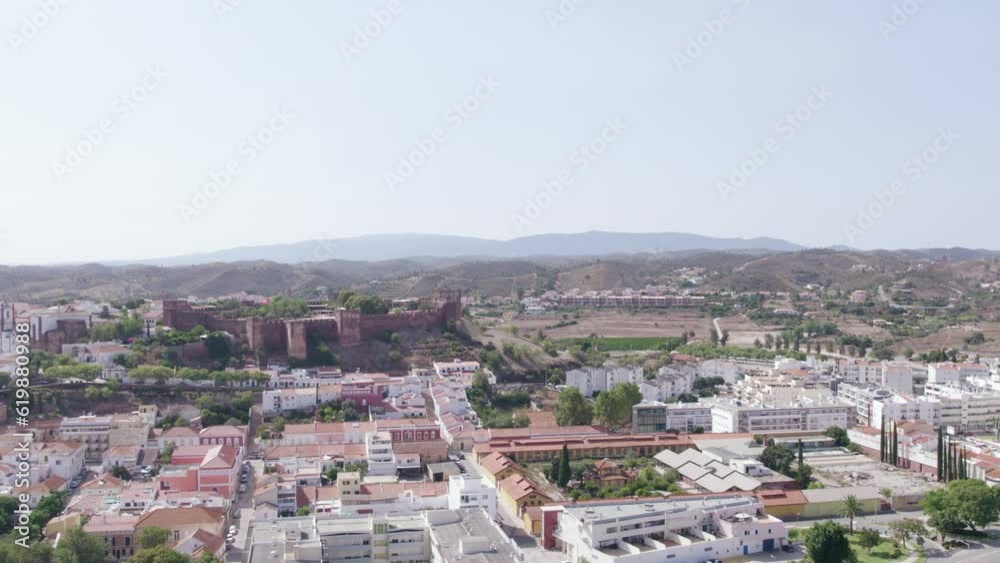 Aerial panoramic view of Algarve countryside medieval city of Silves, and its castle on the hill top, a famous destination Region, in South Portugal. Aerial panoramic view of Algarve countryside medieval city of Silves, and its castle on the hill top, a famous destination Region, in South Portugal.