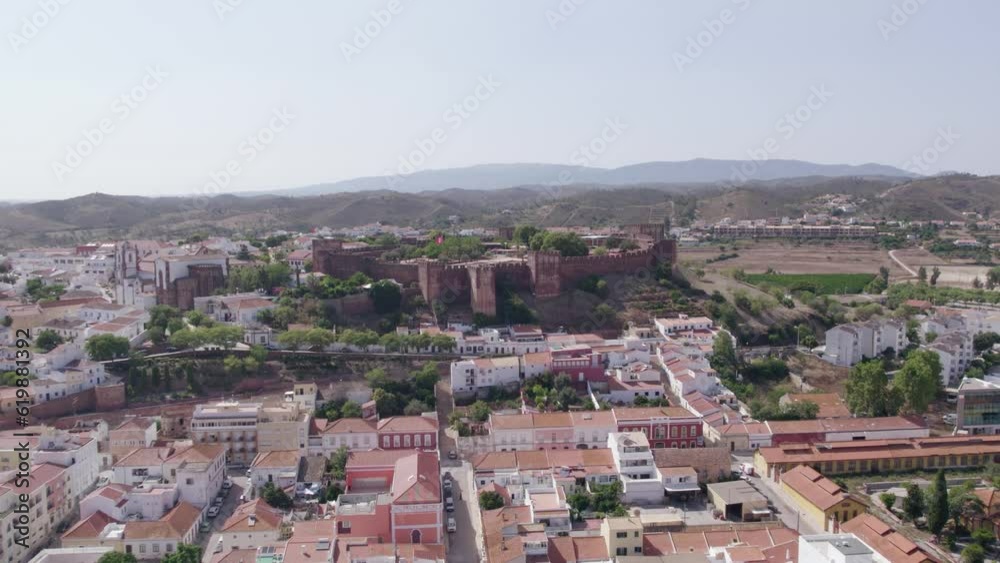 Aerial panoramic view of Algarve countryside medieval city of Silves, and its castle on the hill top, a famous destination Region, in South Portugal. Aerial panoramic view of Algarve countryside medieval city of Silves, and its castle on the hill top, a famous destination Region, in South Portugal.