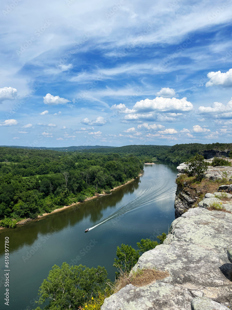 City Rock Bluff in Calico Rock Arkansas over the White River in summer with a blue sky and clouds