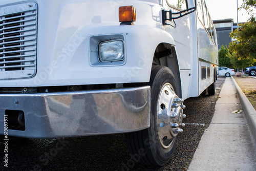 parked white semi truck bumper perspective in parking lot