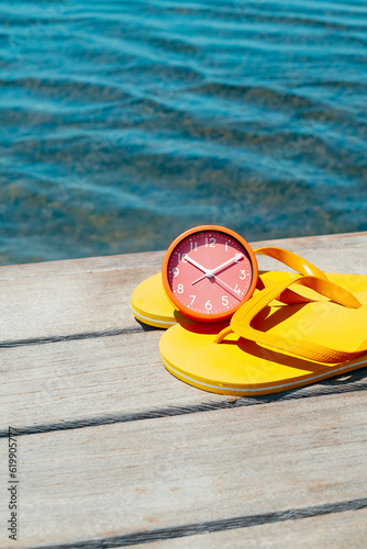 a pair of flip-flops and a clock on a pier