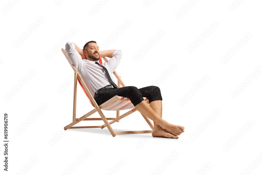 Businessman sitting on a beach chair and enjoying Businessman sitting on a beach chair and enjoying