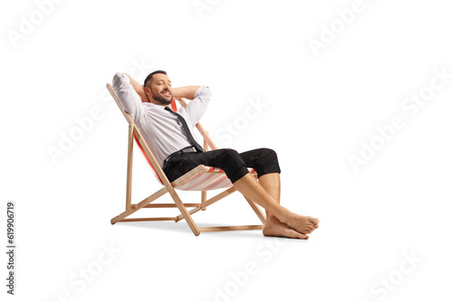 Businessman sitting on a beach chair and enjoying
