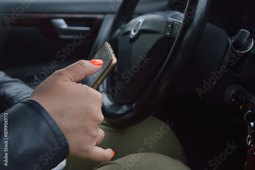 Smartphone in female hands in the car. Woman typing a text message © Елена Пантюхина