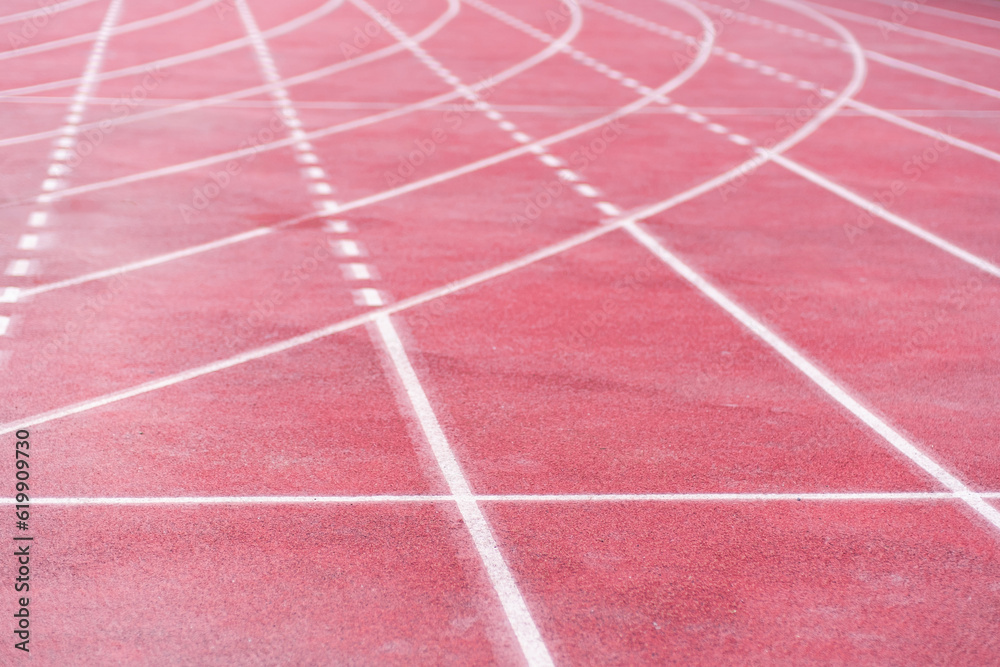 Markings from curve and straight crossed lines on all-weather running track with rubberized surface at contemporary sports arena equipped place for joggers routine training