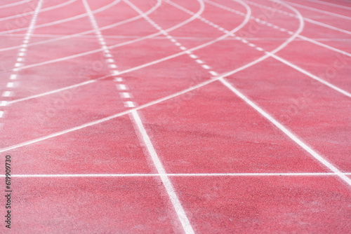 Markings from curve and straight crossed lines on all-weather running track with rubberized surface at contemporary sports arena equipped place for joggers routine training
