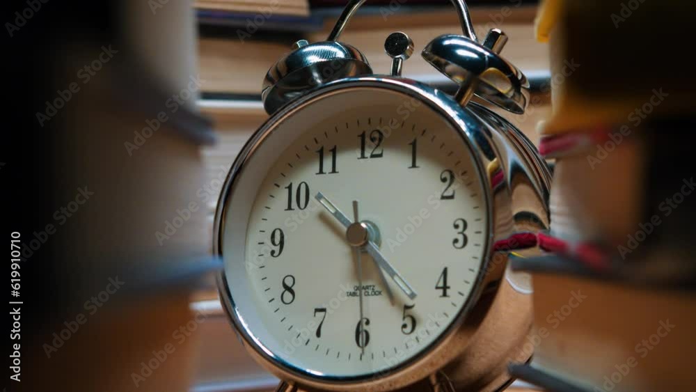 Old Classic Alarm Clock on the Background of Stacks of Books. Clock as a Symbol of Book Time is a Symbol of Knowledge. Concept on the Theme of History, Nostalgia, Culture. Old Classic Alarm Clock on the Background of Stacks of Books. Clock as a Symbol of Book Time is a Symbol of Knowledge. Concept on the Theme of History, Nostalgia, Culture.