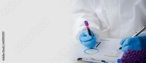 Doctor or research scientist taking blood sample tube to check data in laboratory biotechnology specialist