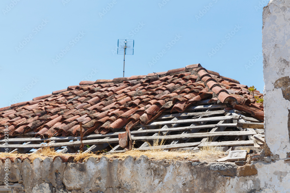 Desolate Charm: Abandoned Rooftop with Missing Tiles and Antenna Desolate Charm: Abandoned Rooftop with Missing Tiles and Antenna