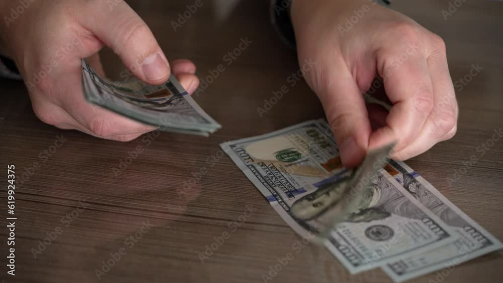 Close up cadres of male hands, successful businessman counts money. Man counts American dollars, men's hands put banknotes in pile. Success and material well-being. Financial independence and wealth.