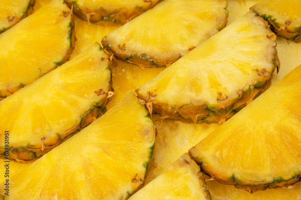 Pineapple juicy yellow slices as a background.