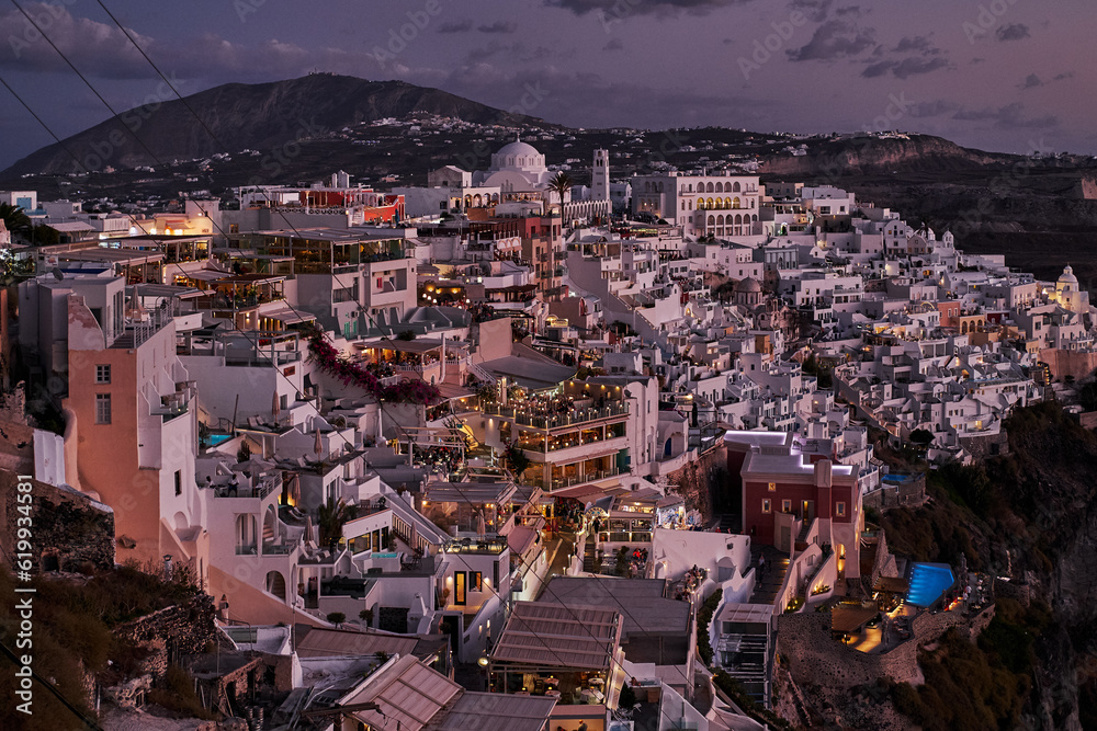 Panoramic Aerial View of Fira Village in Santorini Island, Greece at Dusk - Traditional White Houses in the Caldera Cliffs - Sunset