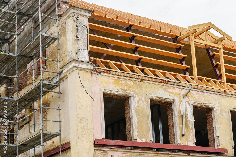 Obraz premium Reconstruction of the roof structures of a historical building using metal and wooden beams
