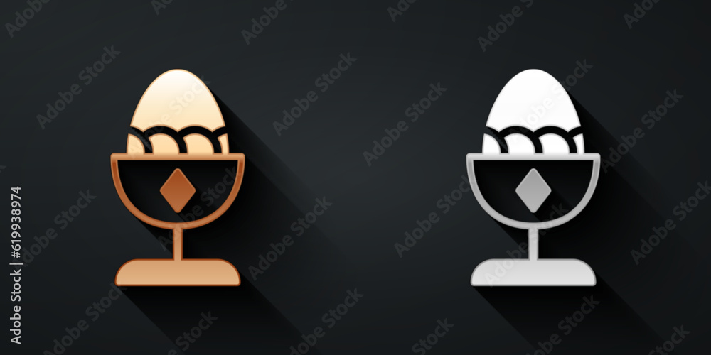 Fototapeta premium Gold and silver Chicken egg on a stand icon isolated on black background. Long shadow style. Vector
