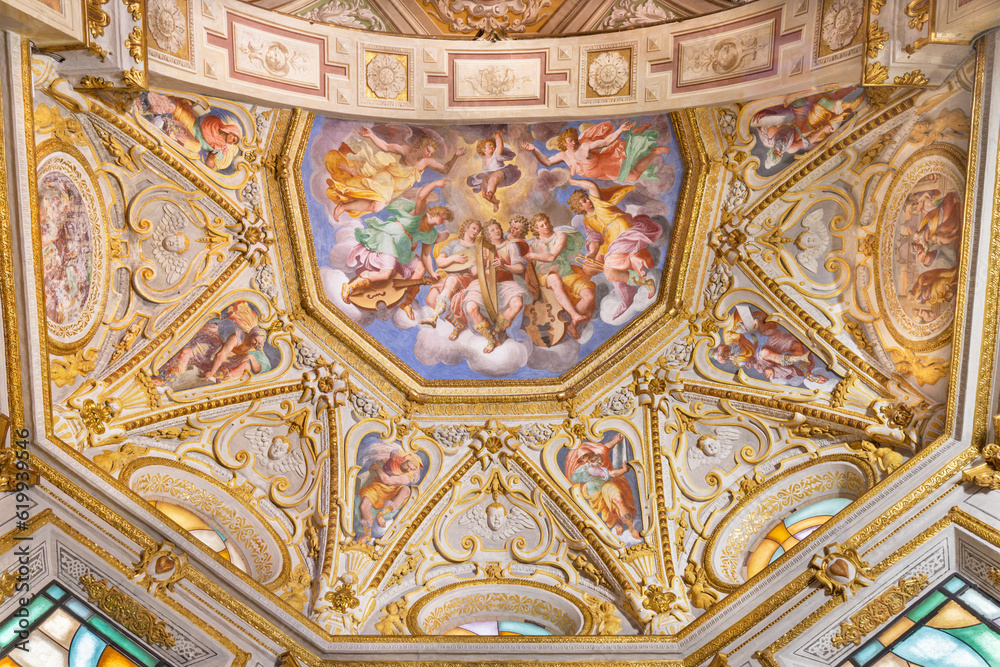 GENOVA, ITALY - MARCH 6, 2023: The ceiling fresco of Choir of angels with the music instruments and prophets in the church Chiesa di Santa Caterina by Andrea Semino (1525 - 1595).