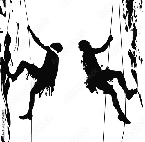 Silhouettes of two people vertical climbing on mountain rock