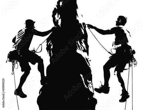 Silhouettes of two man climbing on mountain rock
