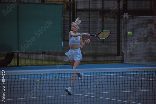 Woman tennis player trains on the tennis court.