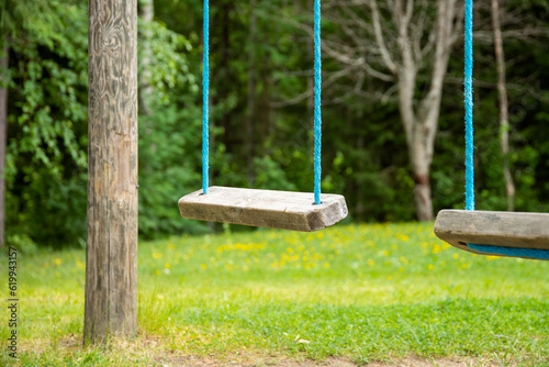 an empty wooden swings with blurry background