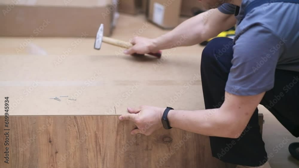Furniture manufacturing and assembling handyman hammering nail into wardrobe for clothes specialist working with quality wood materials profitable carpentry business Furniture manufacturing and assembling handyman hammering nail into wardrobe for clothes specialist working with quality wood materials profitable carpentry business