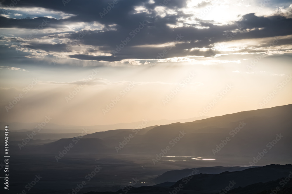 Scenic view from the slopes of the mountain at sunset in the evening with low clouds, evening nature panorama Scenic view from the slopes of the mountain at sunset in the evening with low clouds, evening nature panorama