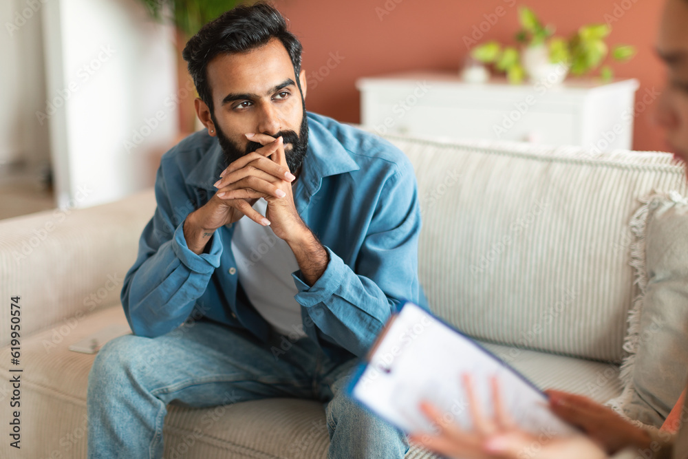 Middle Eastern Bearded Man Thinking Consulting With Therapist In Office