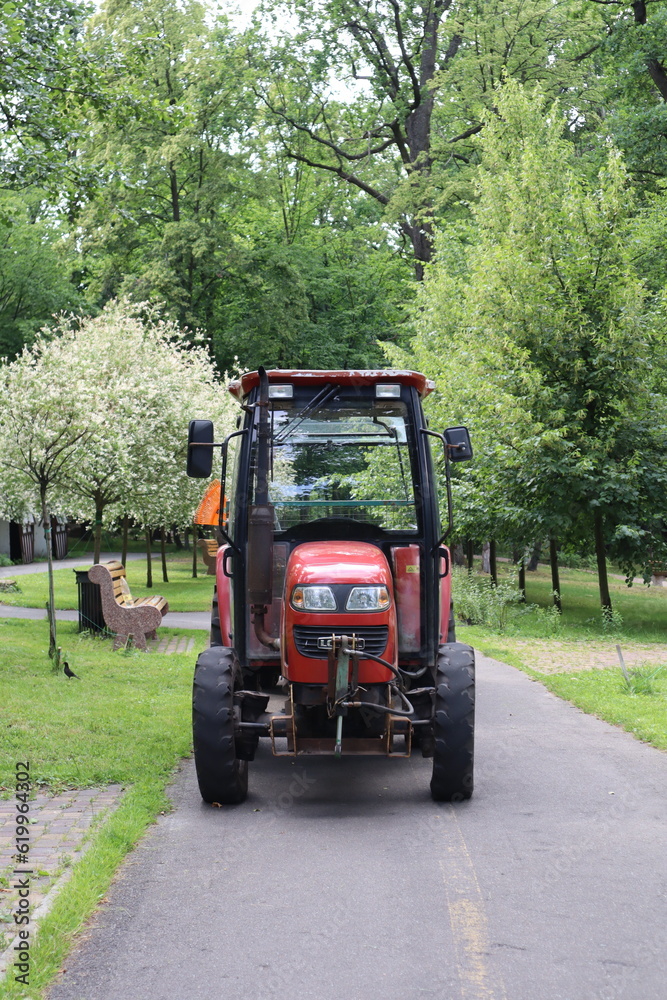 Red tractor on a road. Red tractor on a road.