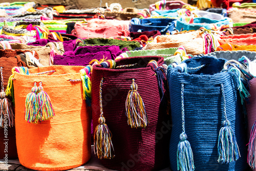 Street selling in Bogota of traditional bags hand knitted by women of the Wayuu community in Colombia called mochilas photo