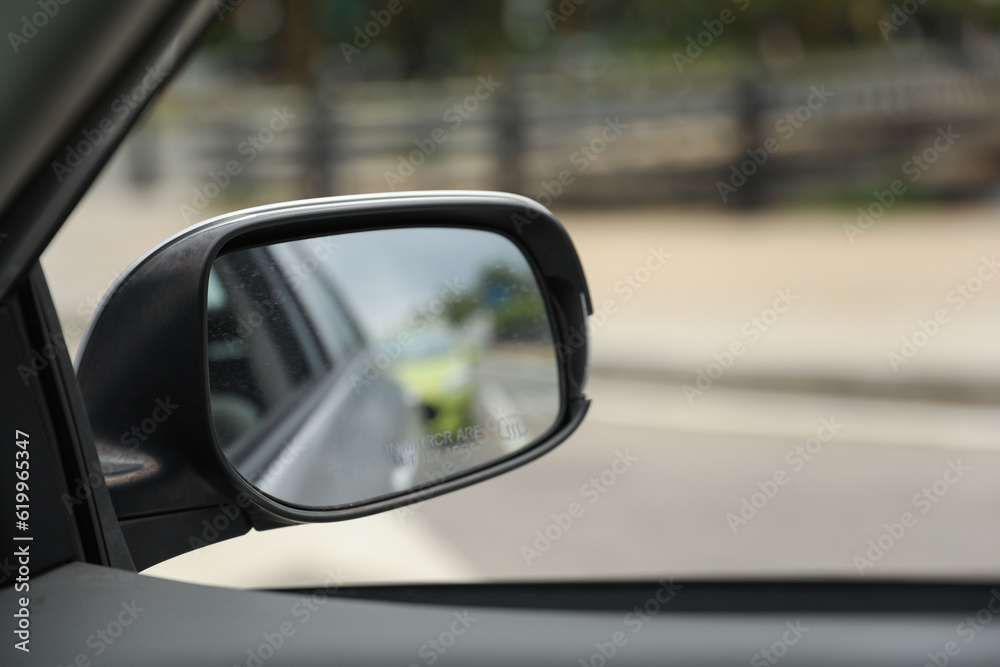 car mirror reflects both practicality and introspection, symbolizing self-reflection, awareness, and the ability to navigate life's paths with foresight