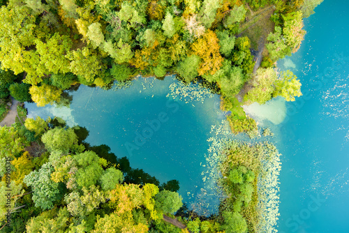 Aerial view of beautiful Balsys lake, one of six Green Lakes, located in Verkiai Regional Park. Birds eye view of scenic emerald lake surrounded by pine forests. Vilnius, Lithuania. © MNStudio
